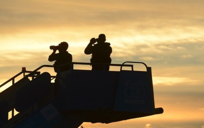 Security officials stand guard as they wait for the plane carrying US President Barack Obama to land in Antalya, Turkey, Sunday, Nov. 15 2015 for the G-20 summit(See picture). The 2015 G-20 Leaders Summit is held near the Turkish Mediterranean coastal city of Antalya on Nov. 15-16, 2015. (Ali Atmaca/Anadolu Agency via AP, Pool)