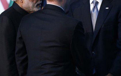 President Barack Obama,( right on the picture), speaks with Russian President Vladimir Putin, back to camera, and Indian Prime Minister Narendra Modi, left, after a group photo with other leaders for the G-20 Summit in Antalya, 