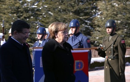 German Chancellor Angela Merkel, right, and Turkish Prime Minister Ahmet Davutoglu inspect a military honour guard during a welcoming ceremony in Ankara, Turkey, Monday, Feb. 8, 2016. 