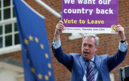Nigel Farage holds up a placard as he launches his party's campaign for Britain to leave the EU(Photo: Ap)