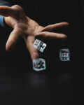 man throws three dice with his hand, concept of gambling