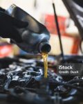 Close up hands of unrecognizable mechanic doing car service and maintenance.